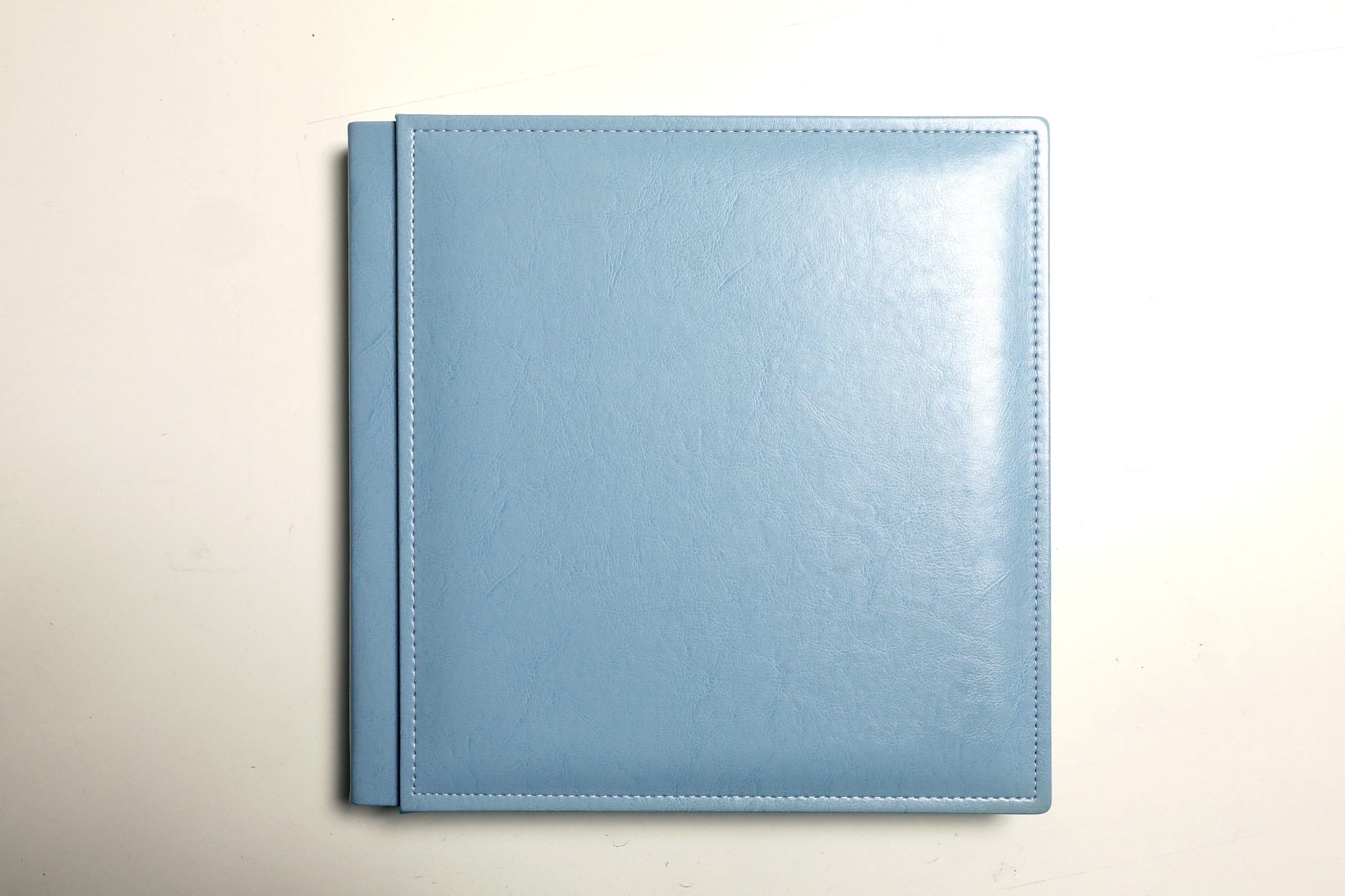 Padded cover of a light blue christening album