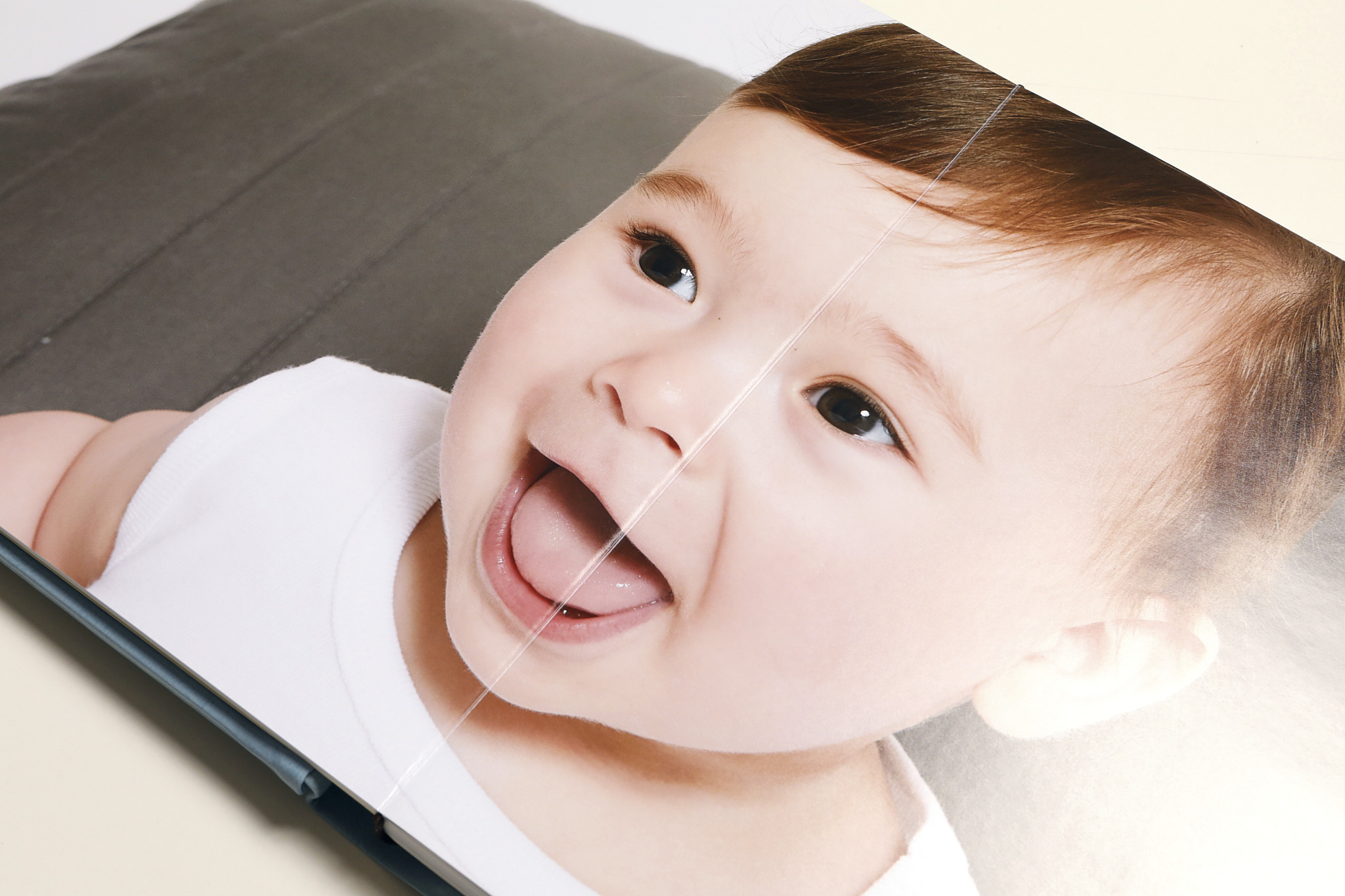 Page of a christening album with a portrait of the baby